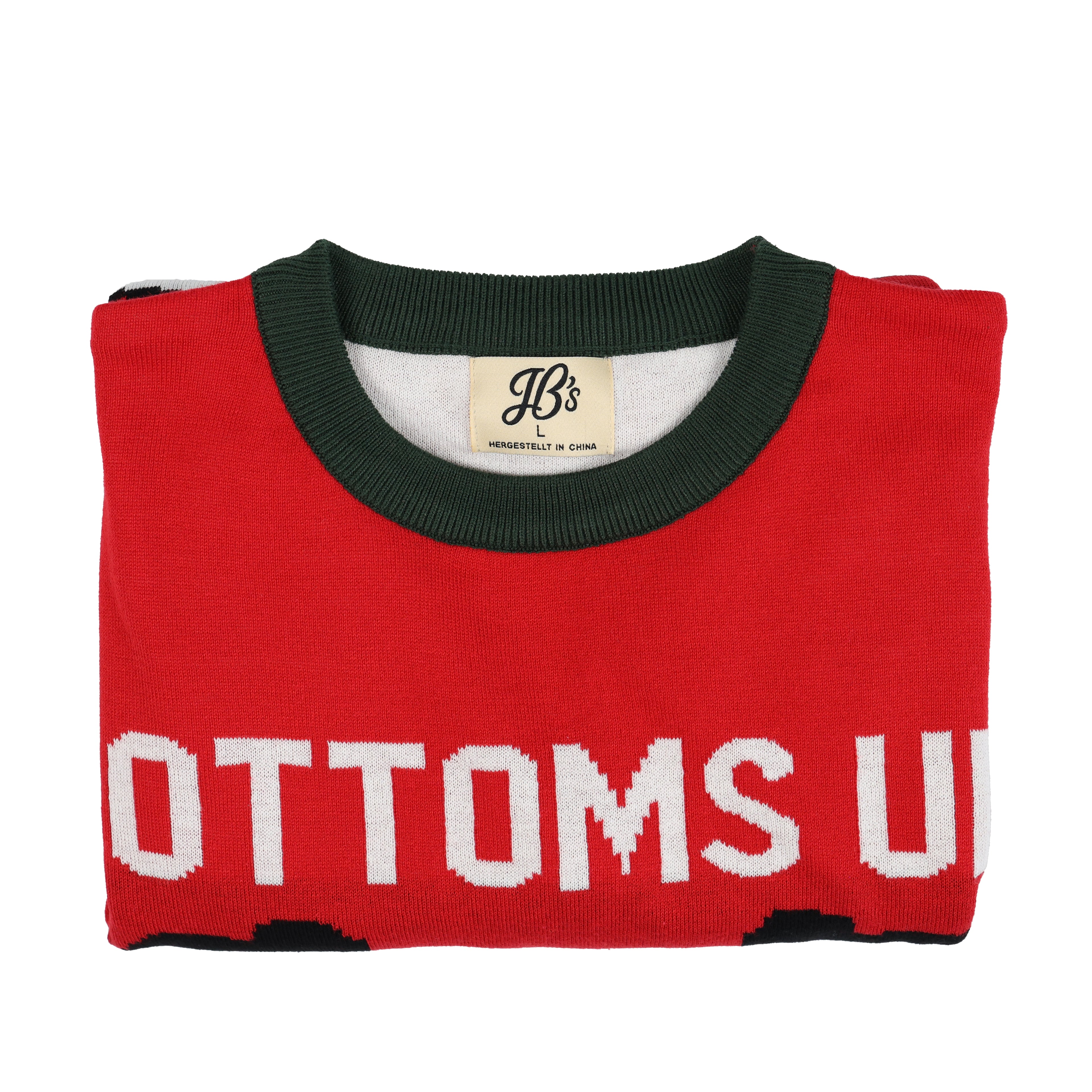 Folded red ugly christmas sweater with green neckline and 'Bottoms Up' text on a white background