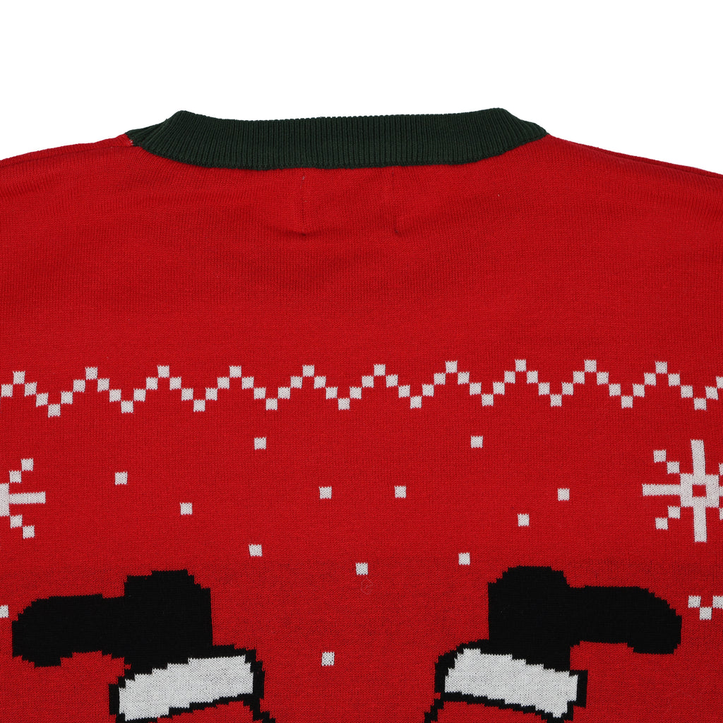 Red ugly christmas sweater with green collar and black and white pattern on a white background