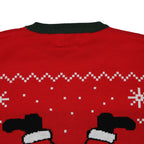 Red ugly christmas sweater with green collar and black and white pattern on a white background