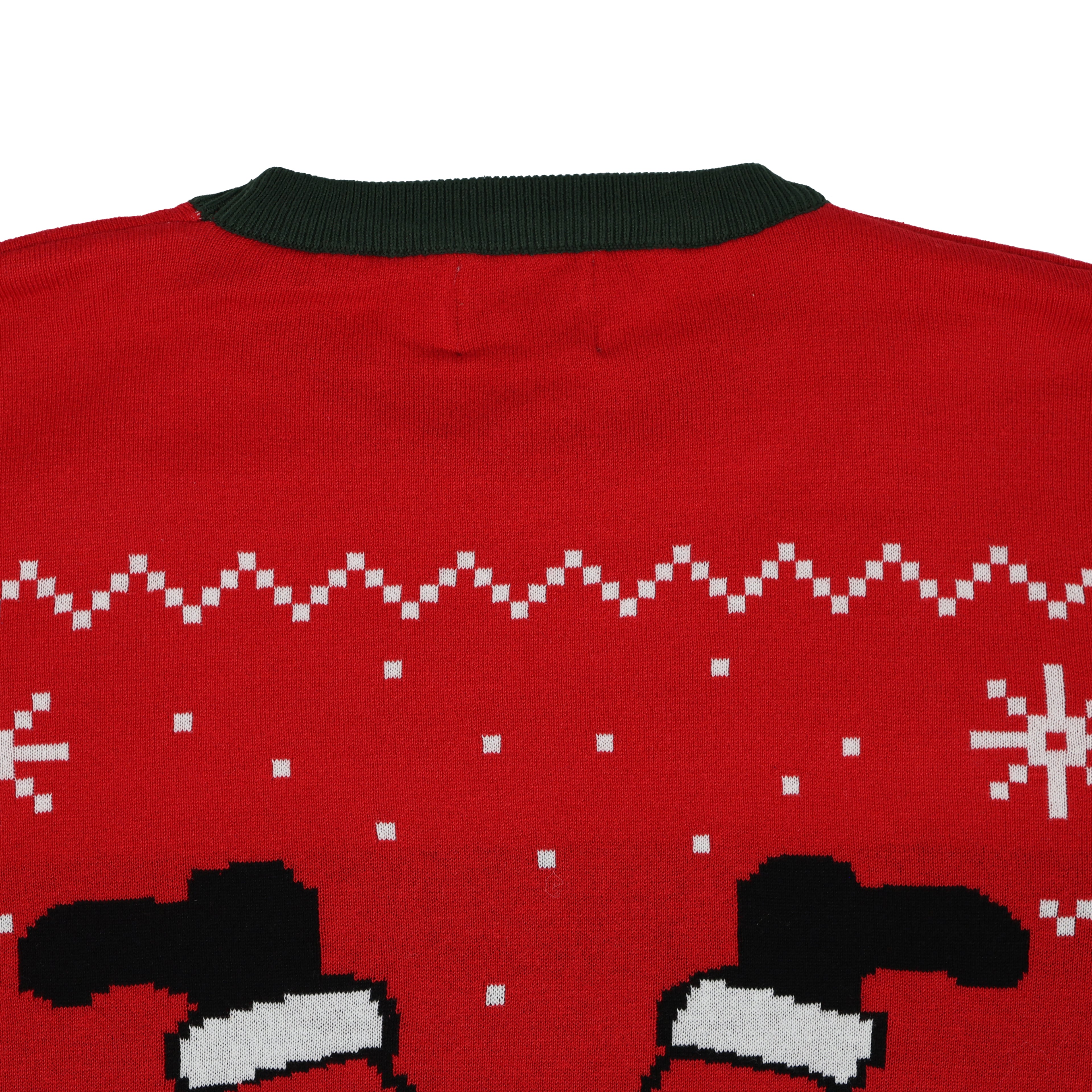 Red ugly christmas sweater with green collar and black and white pattern on a white background