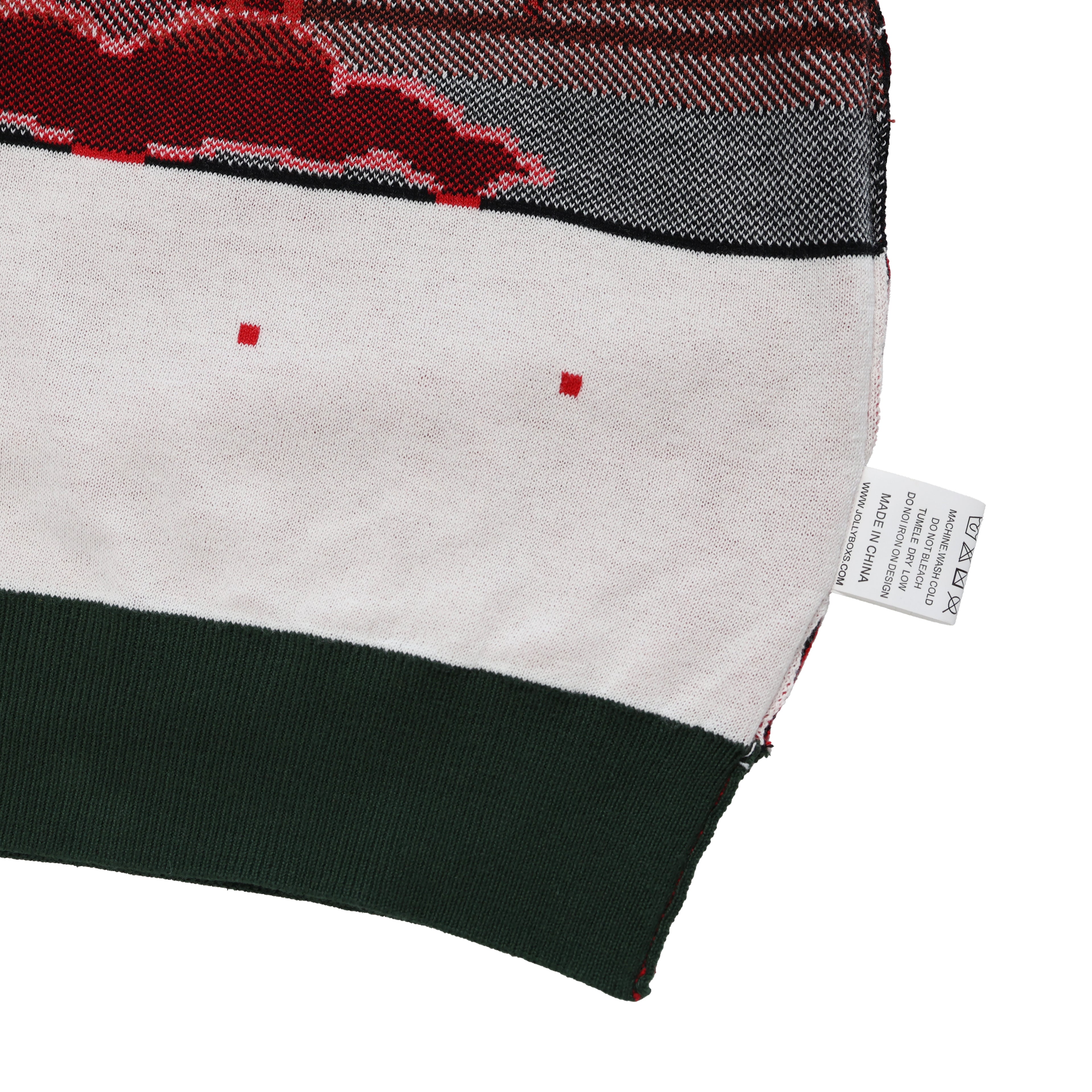 Close-up of an ugly christmas sweater with a brand tag on a white background