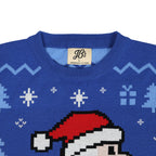 Blue ugly Christmas sweater with pixelated Santa design and 'JB's' label on a white background