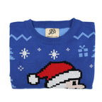 Folded blue ugly Christmas sweater with pixelated Santa design and 'JB's' label on a white background
