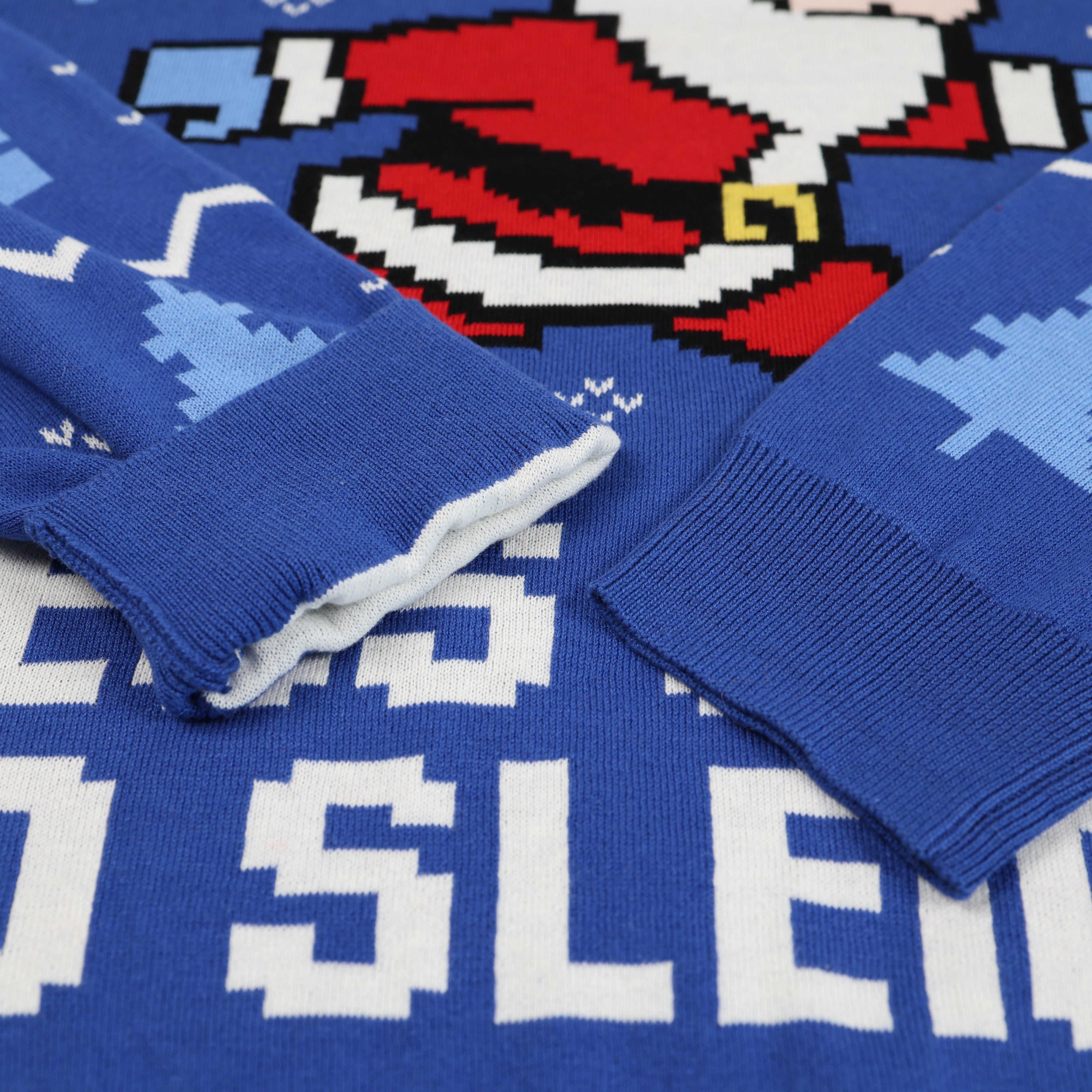 Close-up of blue ugly christmas sweater with pixelated design on a patterned background