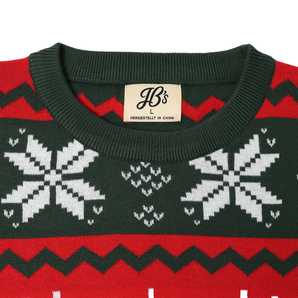 Close-up of an ugly Christmas sweater with snowflake pattern and visible brand label on a white background