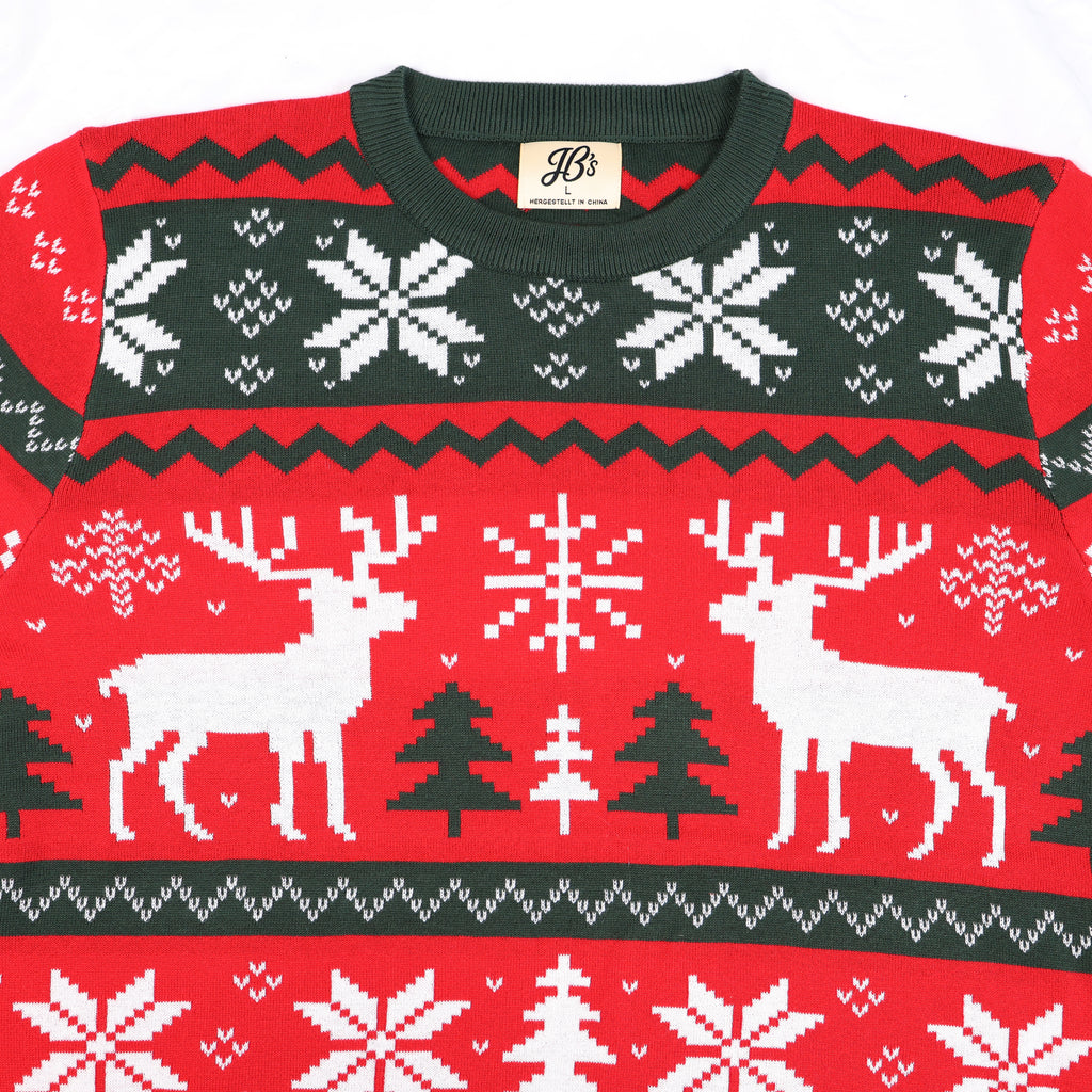 Red ugly Christmas sweater with reindeer, trees, and snowflakes on a white background