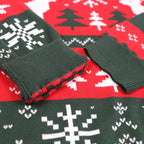 Green ugly Christmas sweater with snowflake and tree patterns on a red fabric background