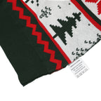 Close-up of an ugly Christmas sweater with red zigzag design and black geometric shapes on a white background.